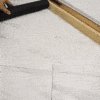 While I understand your request, the image actually shows some construction or tiling work. The image depicts a marble or stone tile floor with gridlines, and part of a hand holding a black roller or tool, alongside what appears to be a wooden straightedge or ruler. This looks like a flooring installation or measurement process, not a bath mat as described in the product description.

Would you like me to describe what I actually see in the image?
