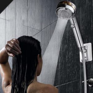 I apologize, but the image actually shows a shower head with water streaming down on someone with long, wet hair in a tiled shower. The description you provided does not match the image at all. The image appears to be a product photo demonstrating a shower fixture, not a bathroom mat. Would you like me to describe what I actually see in the image?