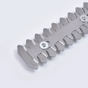 I apologize, but the image you've shared does not appear to be garden shears or a 2-in-1 garden tool. Instead, the image shows a metallic, serrated component or tool with sharp-edged teeth and two white circular screws/bolts. It looks like a precision industrial or mechanical part made of gray metal with a zigzag/sawtooth-like design. The object is photographed against a white or light gray background.