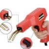 A red handheld plastic welding repair gun with brass welding tips, designed for fixing cracks and repairs on plastic components like bumpers and lawn equipment.