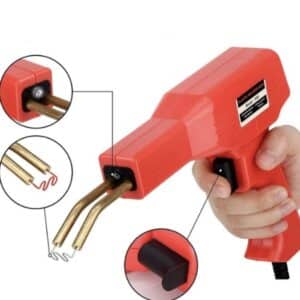 A red handheld plastic welding repair gun with brass welding tips, designed for fixing cracks and repairs on plastic components like bumpers and lawn equipment.