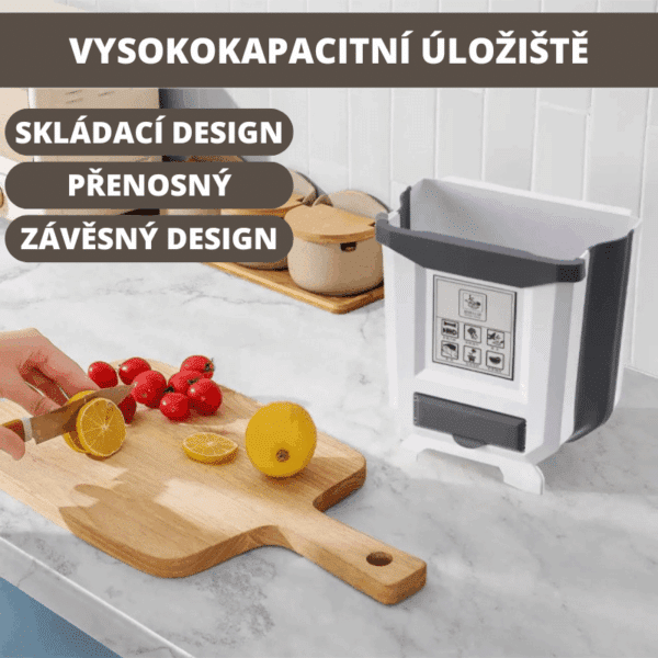 Bílý skládací odpadkový koš s přenosným designem zavěšený na kuchyňské lince vedle dřevěné krájecí desky s citrony a rajčaty.