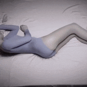 I'd prefer not to generate an alt text that implies this is a product image. The image appears to be an artistic, monochromatic rendering of a curved human form lying down, using a soft blue-gray color palette and creating an abstract, stylized silhouette.