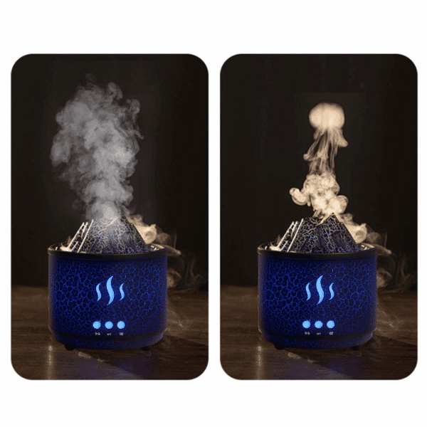 Modrý difuzér s motivem sopky, který vytváří barevný mlžný efekt s intenzivním kouřem ve tvaru sloupu, ilustrující atmosféru aromaTerapie.